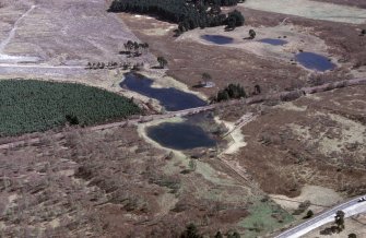 An oblique aerial view of Loch nan Carraigean, Duthil and Rotheirmurchus, Badenoch and Strathspey, looking ESE.