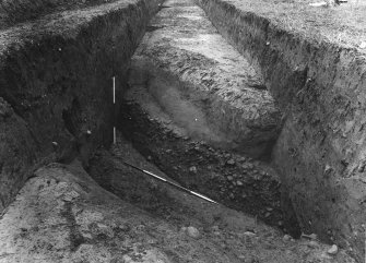 Trench 1, V-shaped ditch turning at NW angle of fort defences.  A note in Adamson's
handwriting on the reverse of the photograph states 'Not a new style of Roman ditch! only
workmen left on their own for a little who became confused with the horizontal layers of 
natural clay, sand and gravel'