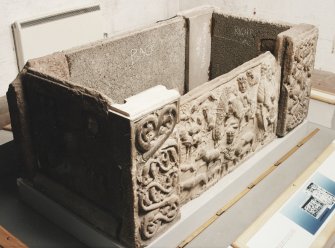 Three-quarter view of sarcophagus, from the left and above.
(Panels 1, 1A, corner posts 1B, 1C)