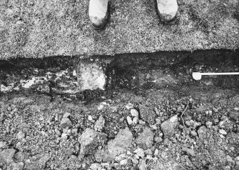 Excavation photograph - Trench I: vertical shot of upright sandstone grave marker (Ii) - from N