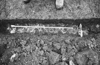 Excavation photograph - Trench I: mortar mass (Il) to the W of slabs of Ik - from N