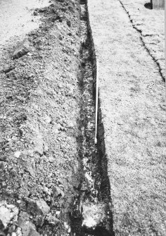 Excavation photograph - General view along Trench I showing fire- reddened slabs (Ik) in foreground