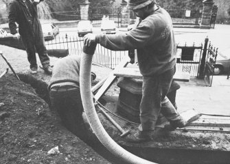Excavation photograph - Conduit pipe being placed in Trench I, W extension - from E