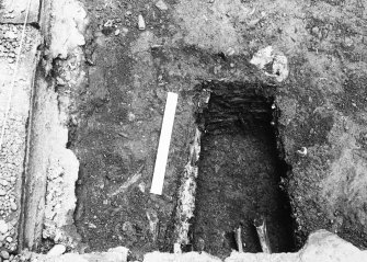Excavation trench revealing grave