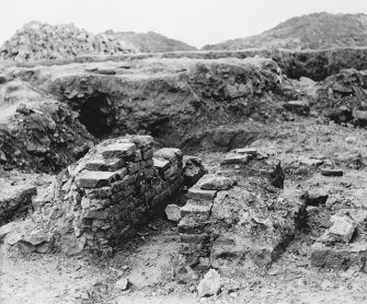Excavation photograph. SE furnace from W.
Copied from A O Curle photograph album MS/28/461.