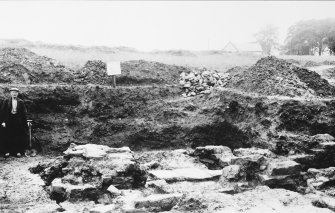 Excavation photograph. View of channelled hypocaust in praetentura, looking S.
Copied from A O Curle photograph album MS/28/461.
Duplicate of ST/1910.