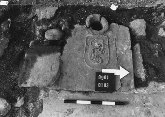 Excavation photographs: General views of site; stone surface; rectangular feature; possible hearth; drain; walls.