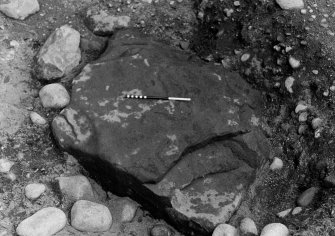 Excavation photograph : cist pit cut into natural gravel (013) and capstone (015) from south.