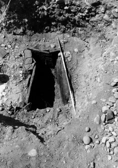 Excavation photograph : deposit in cist containing bone.