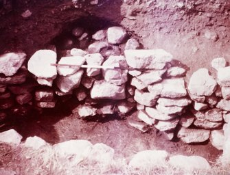 Excavation photograph : alcove in SW wall of souterrain, with blocking.