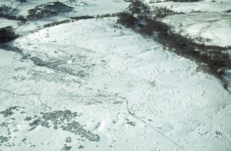 Aerial view of Garbeg barrow cemetery and field system under snow, near Drumnadrochit, Inverness-shire, looking SW.