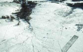 Aerial view of Garbeg barrow cemetery and field system under snow, near Drumnadrochit, Inverness-shire, looking  SSW.