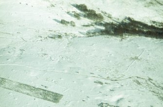 Aerial view of Garbeg barrow cemetery and field system under snow, near Drumnadrochit, Inverness-shire, looking  SE.