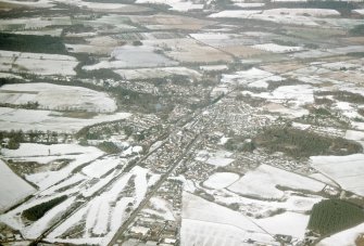 Aerial view of Muir of Ord under snow, looking NW.