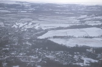 Aerial view of Muir of Ord and the Ord Distillery under light snow, Easter Ross, looking SE.