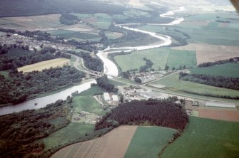 Aerial view of Mosstodloch, A96 bridges across River Spey and part of Fochabers, Moray, looking SE.