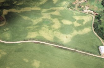 Aerial view of ring ditch cropmark, north of Monboddo, near Laurencekirk, Aberdeenshire, looking NE.