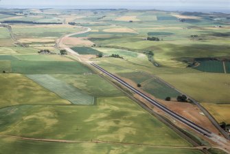 Aerial view of soilmarks N of Cocketty Schoolhouse and dualling of A90, near Fordoun, Aberdeenshire, looking NE.