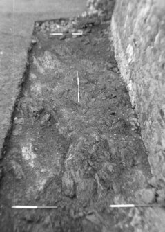Inverlochy Castle
Frame 34 - Excavation completed in the trench against the south curtain wall, showing bedrock over the whole area; from west
