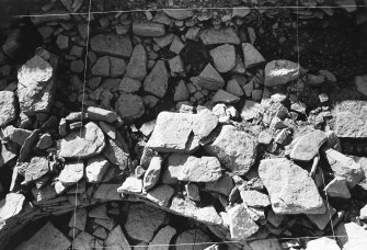 Excavation photograph : trench H - detail showing hearth L293 with base flags and burnt layers.

(see MS/682/120 for detailed description)