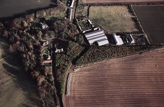 Oblique aerial view centred on the farmsteading and lodge, taken from the W
