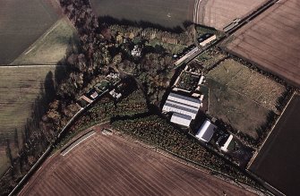 Oblique aerial view centred on the farmsteading and lodge, taken from the SW