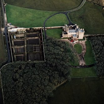 Oblique aerial view centred on the castle and walled garden, taken from the SSW.