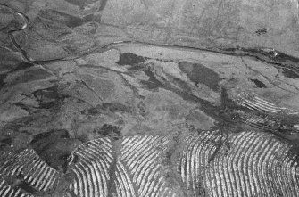 Oblique aerial view centred on the remains of the field-system, taken from the NW.
