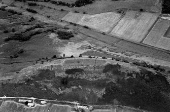 Oblique aerial view centred on the remains of the vitrified fort, taken from the SE.