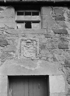 Detail of armorial plaque and window above doorway of cottage, Saltcoats Castle.