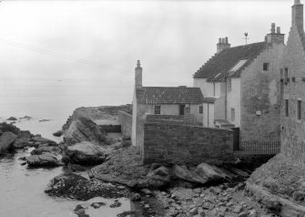 General view of rear of Gyles House, Pittenweem, over rocks.