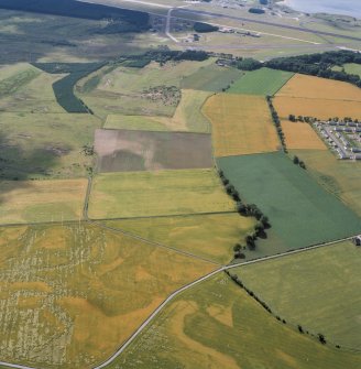 Oblique aerial view showing land surrounding Pitlethie House, and also showing Leuchars Airfield.