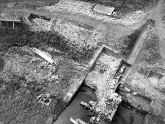 Excavation photographs: Trench XI, junction of causeway and road; junction of causeway and rock-cut edge of moat; general view of trench XII; general view of trench XI from gatehouse; junction of causeway and rock cut edge of moat with timber 2C and 3C; trench XI, roadway; trenches XI and XII showing continuation of roadway.
