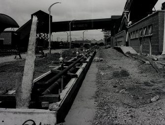 Image from photo album titled 'Braehead Oil Conversion', Oil unloading trench - pipes at rail sidings