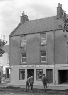 View of front elevation of 35-39 High Street, Pittenweem, with shop sign, 'Photographic Dealer  J.L IMRIE  Incorporated Photographer'.