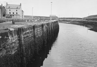 General view of quay wall and The Lobster Pot behind, Eyemouth.