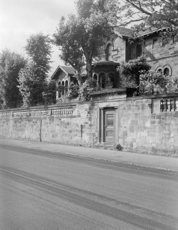 General view of house and outer wall to main road, The Knowe, 301 Albert Drive, Glasgow.
