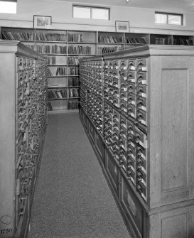 Interior.  View within library showing wooden cabinets containing drawers of index cards, cross-referencing Reports with reference books,journals and other records