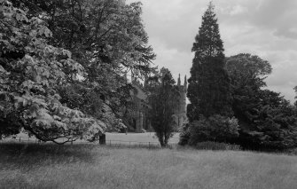 General view of Cambusnethan Priory from N partly obscured by trees.