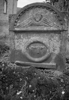 View of gravestone of George Brown, 1730, with winged soul and dividers set-square and axe, in the churchyard of Forteviot Parish Church.