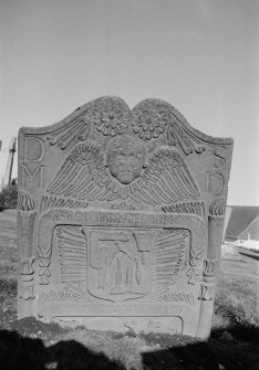 View of gravestone commemorating May Duff dated 1762 in the churchyard of Errol Parish Church. The stone features double rosette with double torches of Life and Death, winged soul over ribband inscribed 'After Death Life. Hors Est Boni Viri Natalis', and shield with the tools of a mason (setsquare, folding ruler, dividers chisel, hammer and mallet.
Insc: 'D.M  S.D'.