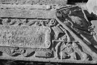 Detail of the tombstone commemorating Alexander Omay, 1639, in the churchyard of Errol Parish Church, with skeleton with arrow of death, scythe and hourglass, and a figure known as the 'King of Terrors'.