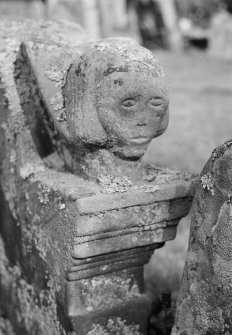 Detail of carved head on gravestone in the churchyard of Old Logie Church.