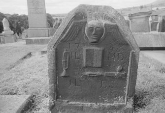 View of gravestone inscribed 'IL MD IL ES' and 1746 in the churchyard of Kilsyth Parish Church.