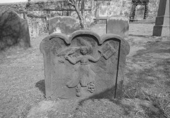 View of E face of headstone commemorating Peter Steven and Isobel Maltman, 1747, in the churchyard of Bo'ness Parish Church, showing dancing angel with book and trumpet in hands.
