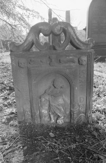 View of E face of headstone for T.D. and A.H., in the churchyard of Bo'ness Parish Church, showing openwork top, and draped figure in arch in centre of face.