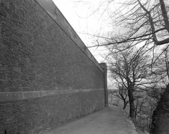 View of S stone wall surrounding prison.