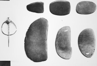 General view of flaying knives and Viking brooch.