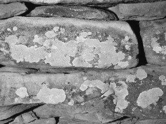 Cup-marked stone built into cairn.