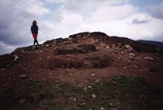 Detail of erosion to SW side of cairn; Mr Angela Gannon (RCAHMS) in picture